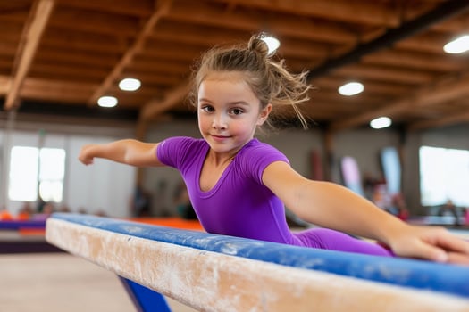 A young girl is on the balance beam in an indoor gym photo
