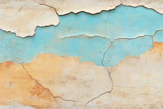 A cracked wall with blue and orange paint photo