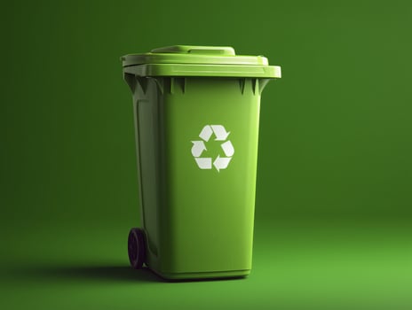 Green recycling bin with white recycling symbol it, placed against matching green background, emphasizing eco friendly waste management photo