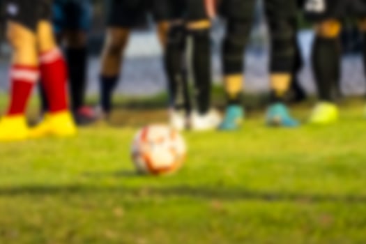 Blur background of soccer ball on a grassy field photo