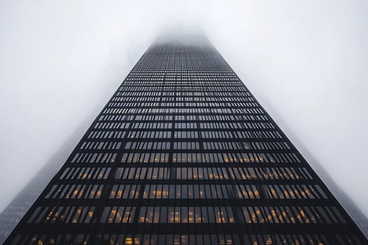 A tall building in the fog with no windows photo