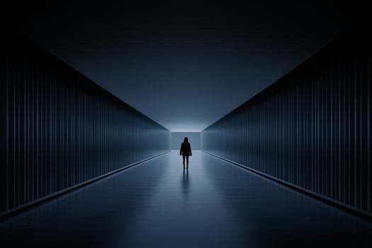 A person standing in the middle of a dark hallway photo