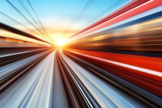 A train speeding down the track at sunset photo