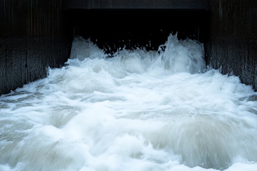 A man is standing in a water filled tunnel photo