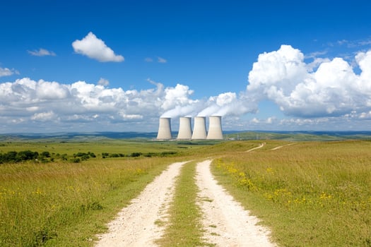 A dirt road leading to two cooling towers photo