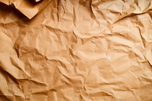 Crumpled brown paper background with copy space photo