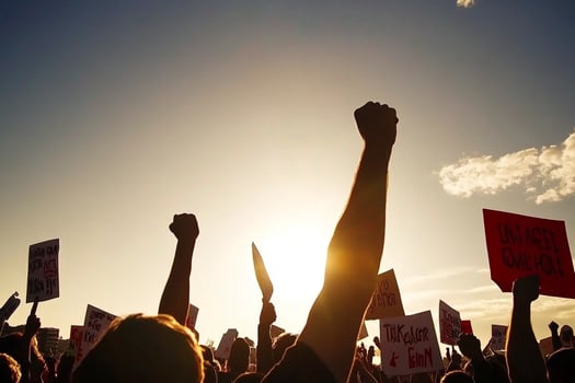 People holding signs in the sun with the sun in the background photo