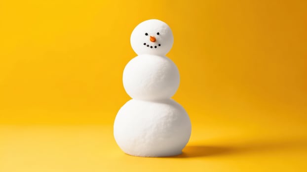 Minimalist snowman against vibrant yellow backdrop photo