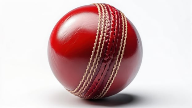 Red cricket ball on white background photo