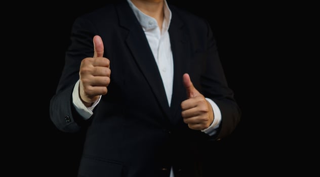 A businessman gives the client satisfaction thumbs up for the best excellent services. photo
