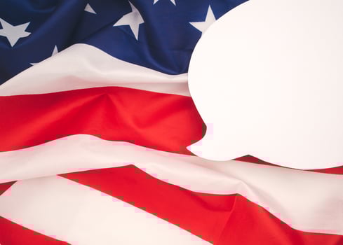 Top view of a blank white speech bubble over the American flag background. photo