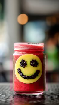 Delicious Red Smoothie with a Happy Smiley Face Decoration. photo