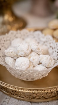 Delightful powdery cookies presented on an ornate golden tray. photo