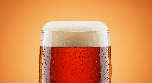Glass mug with fresh cold red beer on a yellow background. Close-up template for Oktoberfest, International Beer Day and beer advertising and menu with place for text. photo