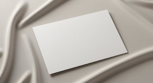 Blank White Card on Silver Satin Fabric Background for Creative Design photo