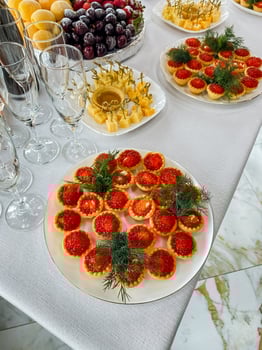 A beautifully arranged dining table with assorted plates of delicious food and elegantly placed wine glasses, creating a delightful atmosphere for guests to enjoy their meals photo