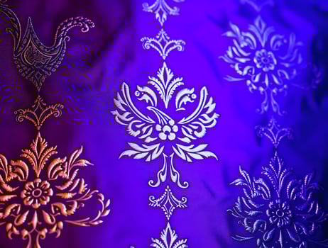 Vibrant Purple Fabric with Intricate Gold and Silver Embroidered Designs photo