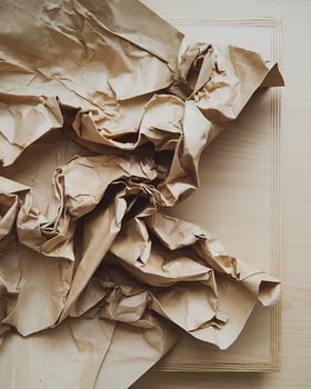 Crumpled Brown Paper Texture on Light Wood Surface kraft paper photo
