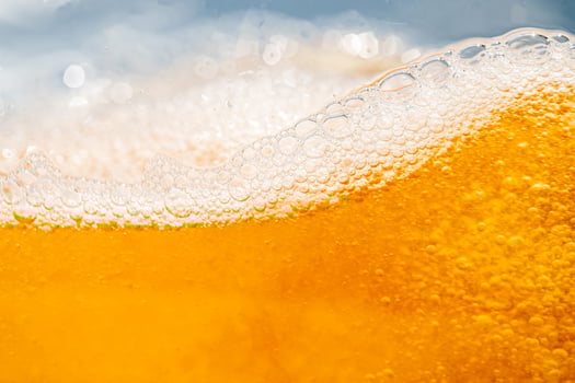 Close up bright orange Oil or beer splash texture and nature waves, Beautiful waves curve and little bubbles smooth for graphic design and background, Oil Bubbles, Soft beer bubbles, Selective focus, photo