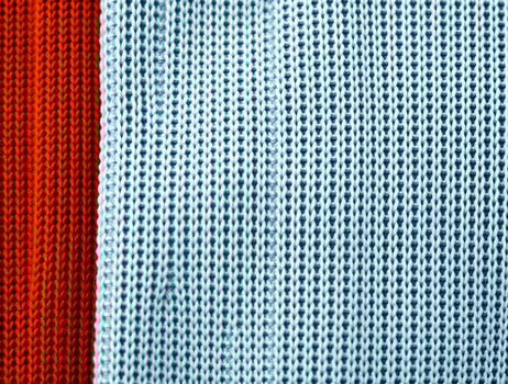 Knit Fabric Texture Closeup of Red and Light Blue Knitted Material Perfect for Textile Designs and Backgrounds photo