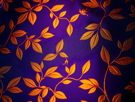 Luxurious Golden Leaf Pattern on Deep Purple Fabric Elegant Texture Background photo