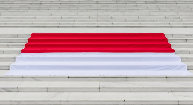Flag of Indonesia Draped on White Marble Steps for Celebration photo