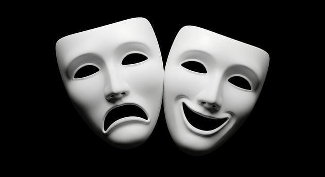 Two white theatrical masks with a sad face photo