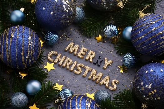 Merry Christmas inscription on blue background with Christmas decorations. photo