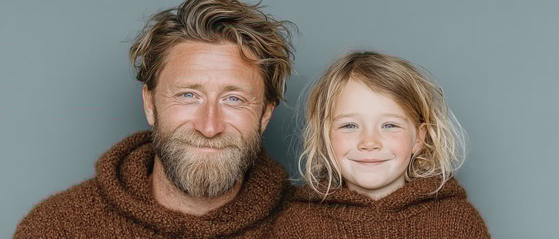 Father and child sharing smiles in cozy sweaters photo