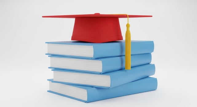 A graduation cap sits on top of a stack of books photo