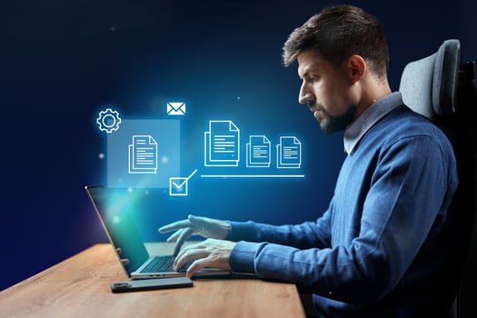 Business professional working on a laptop with digital elements in a modern office environment photo