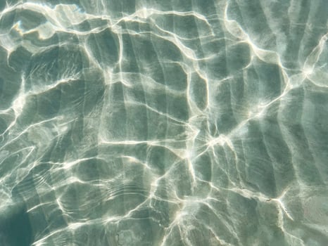 Light reflection on the sea sand bottom through transparent water, Abstract textured background wallpaper photo