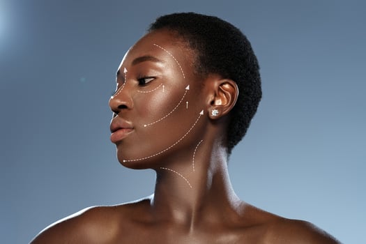 Beauty and elegance showcased through a profile of a woman with a smooth complexion against a simple background photo