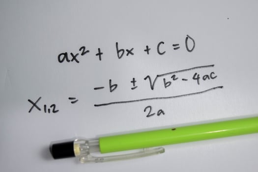 general quadratic equation write on book isolated on Wooden Table. photo
