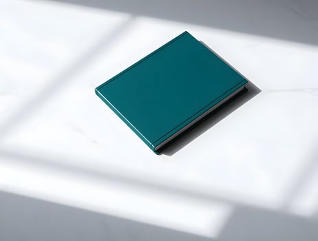A blue book on a white surface photo