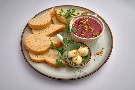 A Delicious Plate Featuring Sliced Bread and Creamy Dip with Nuts, Perfect for a Casual Snack or an Elegant Appetizer Presentation photo