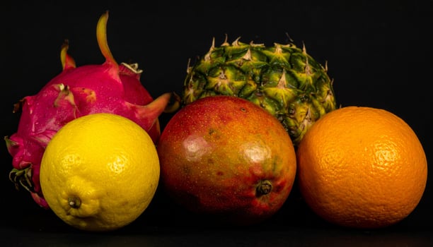 Vibrant Assortment of Fresh Tropical Fruits Against Dark Background in Studio Light photo
