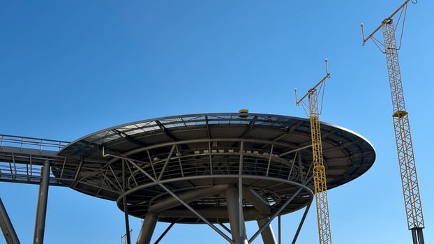 A Stunning Futuristic Structure Set Against a Bright Clear Sky with Brilliant Blue Hues photo