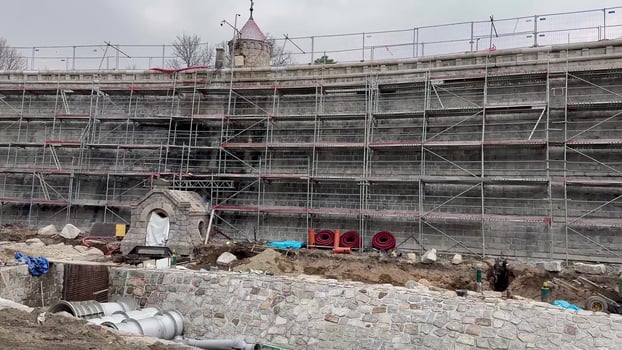 A construction site featuring scaffolding, materials, and various building activities photo