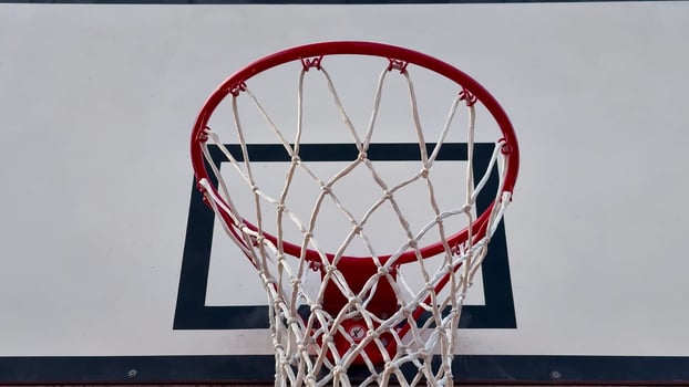 A Dynamic Basketball Hoop Perspective capturing the thrilling action and energy of the game photo