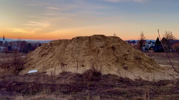 A beautiful Dunelike Sand Mound gracefully set against a mesmerizing sunset backdrop photo