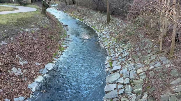 A Serene Stream is Flowing Gracefully Through a Beautifully Tranquil Landscape Scene photo