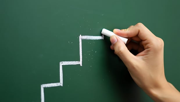 Hand Drawing Staircase on Green Chalkboard Illustrating Success Path and Career Advancement Concept photo