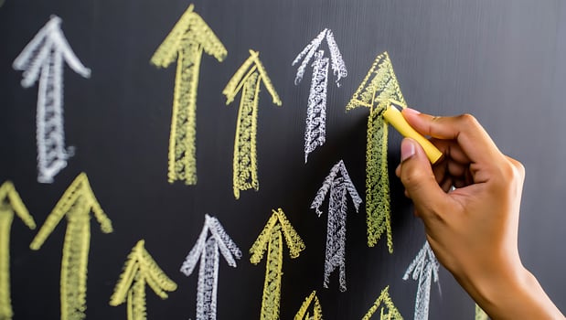 Hand Drawing Upward Arrows on Blackboard with Chalk Depicting Business Growth and Positive Trends Success and Advancement photo