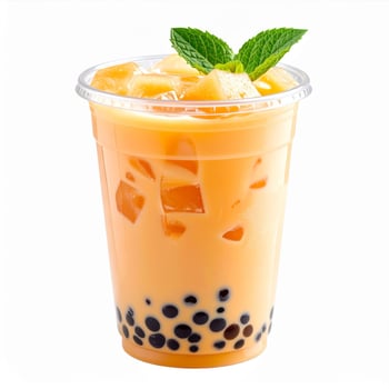 Refreshing Orange Boba Tea Drink with Mint Leaves in Clear Plastic Cup on White photo