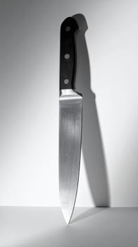 Silver Steel Serrated Kitchen Knife with Black Handle on White Background photo
