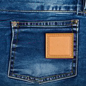 Denim Blue Jeans Pocket Close Up with Tan Leather Label on Light Fabric photo
