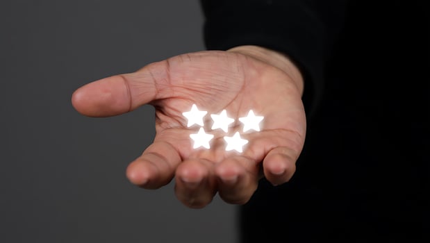 Five Glowing Stars in Hand Concept of Excellent Service and Customer Satisfaction a Top Rating with Positive Feedback photo