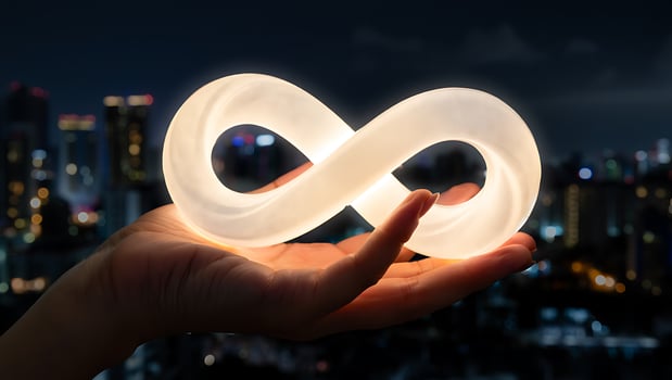 Infinity symbol glowing in hand over city skyline at night showcasing the concept of eternity and limitless potential photo