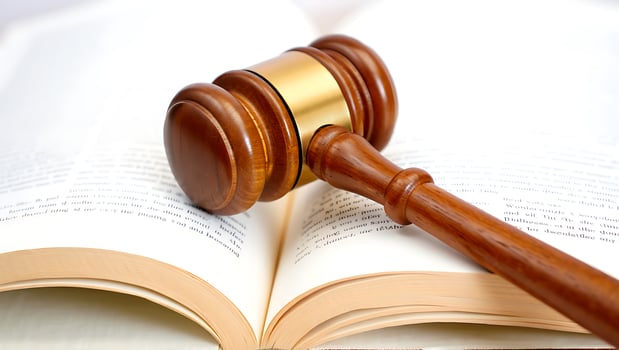 Law and Justice Gavel Resting on an Open Legal Book Representing Legal Proceedings and Judicial Decisions photo